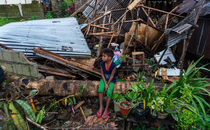 A boy sits in an area of Surigao City in the Philippines that was badly damaged by Typhoon Rai in December, 2021.