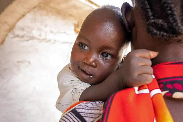 Six-month-old Anei of South Sudan with his mother, Nyaweer, after being successfully treated for severe acute malnutrition at a UNICEF-supported stabilization center. Six-month-old Anei of South Sudan with his mother, Nyaweer, after being successfully treated for severe acute malnutrition at a UNICEF-supported stabilization center.