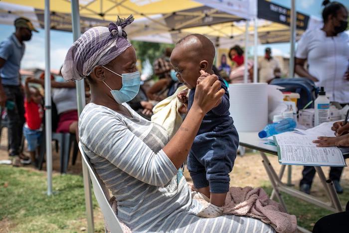Neliswa Mnana holds her son, 6-month-old Phatu, at a pop-up vaccination site run by the Zwakala campaign in South Africa.
