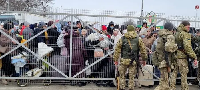 Families with small children fleeing escalating conflict in Ukraine waiting to cross into Romania at the Porubne-Siret border on Feb. 26, 2022. Families with small children fleeing escalating conflict in Ukraine waiting to cross into Romania at the Porubne-Siret border on Feb. 26, 2022.