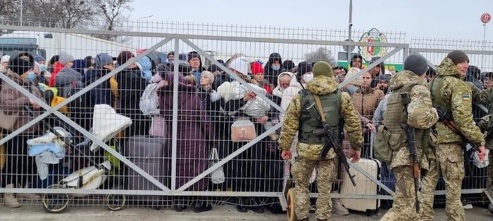 Families with small children fleeing escalating conflict in Ukraine waiting to cross into Romania at the Porubne-Siret border on Feb. 26, 2022.