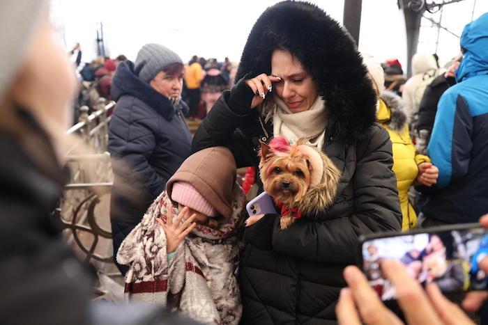 A family waits to board an evacuation train in Lviv, western Ukraine, on Feb. 27, 2022.