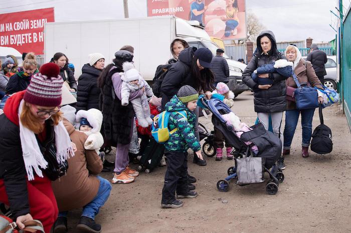 In western Ukraine on March 5, 2022, children and families make their way to the border to cross into Poland.