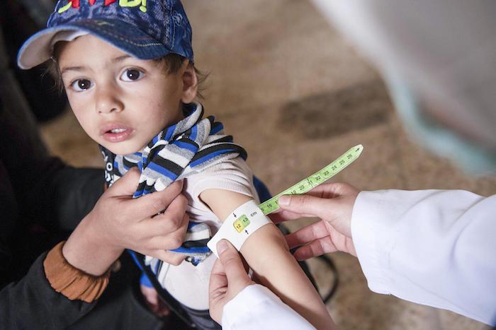 Ishak, 2, is screened for malnutrition by a member of the UNICEF-supported mobile health and nutrition team in Jarba village, east Ghouta, rural Damascus, Syria, on April 3, 2022.