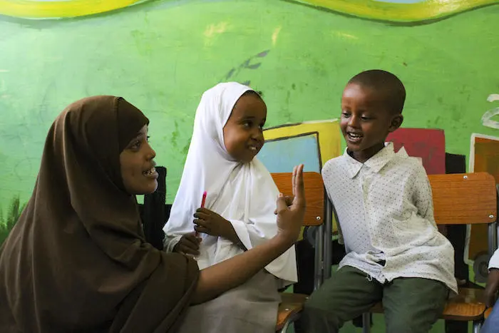 Two pre-primary school students learn how to count to 10 in Arabic at one of 12 UNICEF-supported community schools in Puntland state, Somalia. Two pre-primary school students learn how to count to 10 in Arabic at one of 12 UNICEF-supported community schools in Puntland state, Somalia.