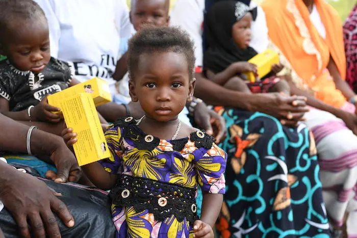 A child in Burkina Faso holds a box of micronutrient powders that UNICEF distributes to help prevent malnutrition in at-risk children. A child in Burkina Faso holds a box of micronutrient powders that UNICEF distributes to help prevent malnutrition in at-risk children.