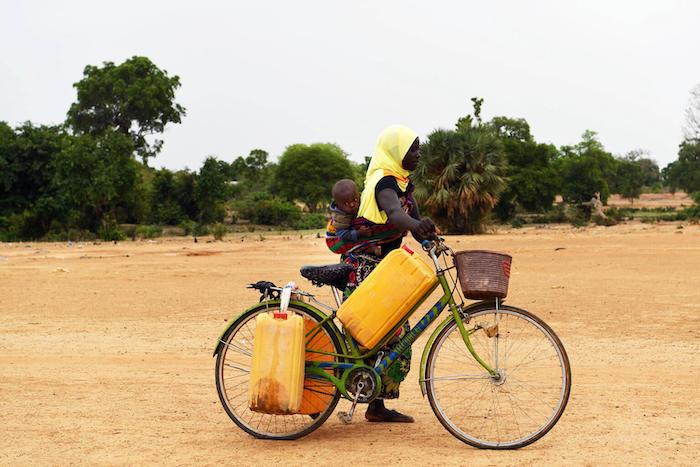 A woman with her child on the way to a well, in Fada, in east Burkina Faso.