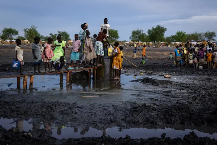 Drawing water at a borehole in the river bed running through the village of Aburoc, South Sudan, where thousands of people, displaced by fighting near their homes, live in the open. © UNICEF/UN065988/Hatcher-Moore