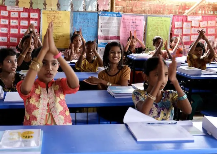 Adolescent girls cheer for one of their classmates after she reads aloud in a UNICEF learning center in Rohingya refugee Camp 15, Cox's Bazar, Bangladesh on May 11, 2022. Adolescent girls cheer for one of their classmates after she reads aloud in a UNICEF learning center in Rohingya refugee Camp 15, Cox's Bazar, Bangladesh on May 11, 2022.