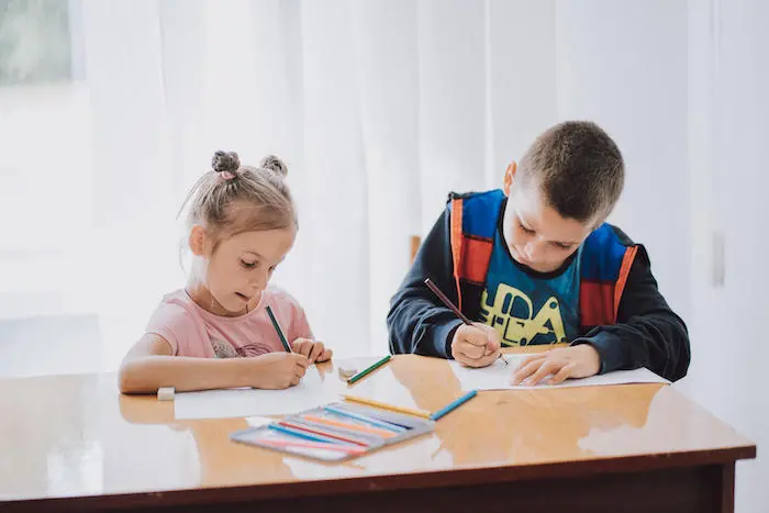 Two children coloring and learning mine safety through play in Ukraine