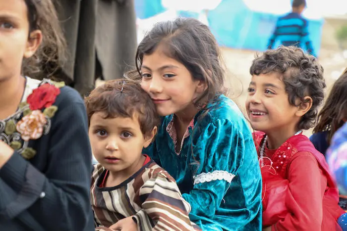 Three children stand in the camp where they live in Afghanistan since their homes were destroyed in recent flash floods Three children stand in the camp where they live in Afghanistan since their homes were destroyed in recent flash floods