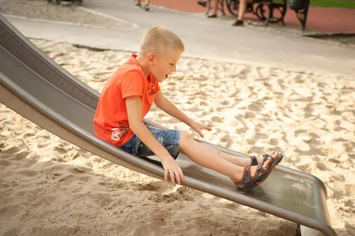 A refugee child from Ukraine slides down in a playground in Krakow, Poland A refugee child from Ukraine slides down in a playground in Krakow, Poland