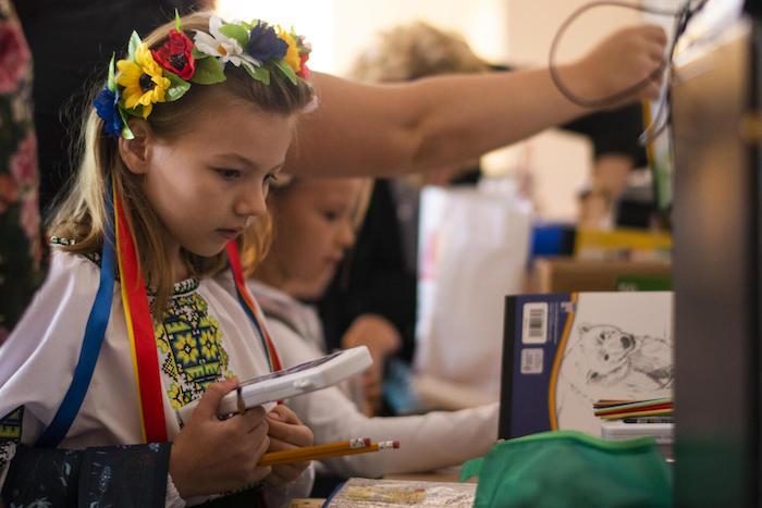 Emilia, 7 from Irpen, Ukraine is looking through the learning materials gifted to her on the first day of school at her new school in Krakow, Poland.