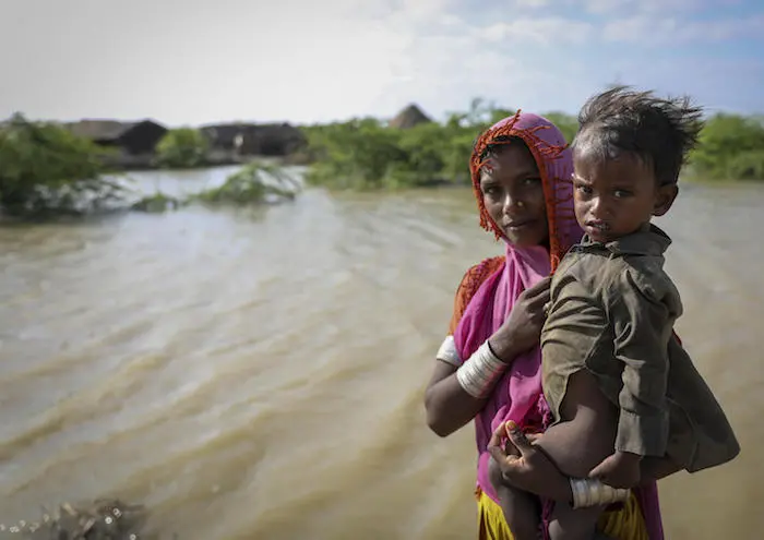A mother and her 16-month-old child, Hera, beside floodwaters near their village in Umerkot district, Sindh Province, Pakistan. A mother and her 16-month-old child, Hera, beside floodwaters near their village in Umerkot district, Sindh Province, Pakistan.