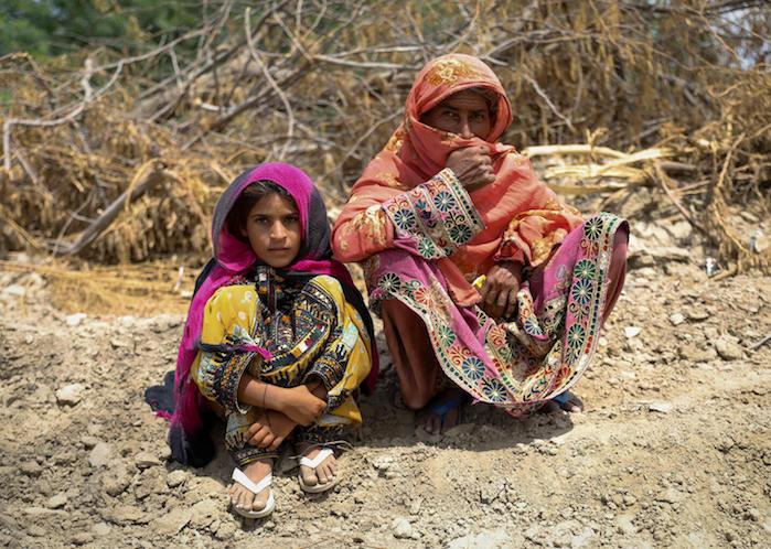 8-year-old Rukhsana and her mother wait to receive a UNICEF WASH (water, sanitation and hygiene) kit in Lasbela district, Balochistan Province, Pakistan.