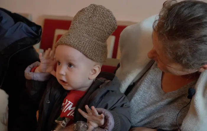 A mother in Ukraine puts a woolen hat on her 10-month-old infant, part of a winter kit from UNICEF. A mother in Ukraine puts a woolen hat on her 10-month-old infant, part of a winter kit from UNICEF.