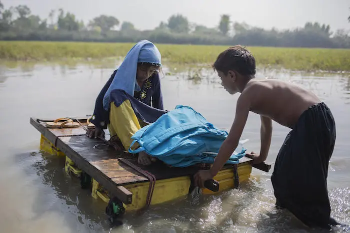 A girl and boy navigate contaminated floodwaters in Jacobabad district, Sindh Province, Pakistan. A girl and boy navigate contaminated floodwaters in Jacobabad district, Sindh Province, Pakistan.