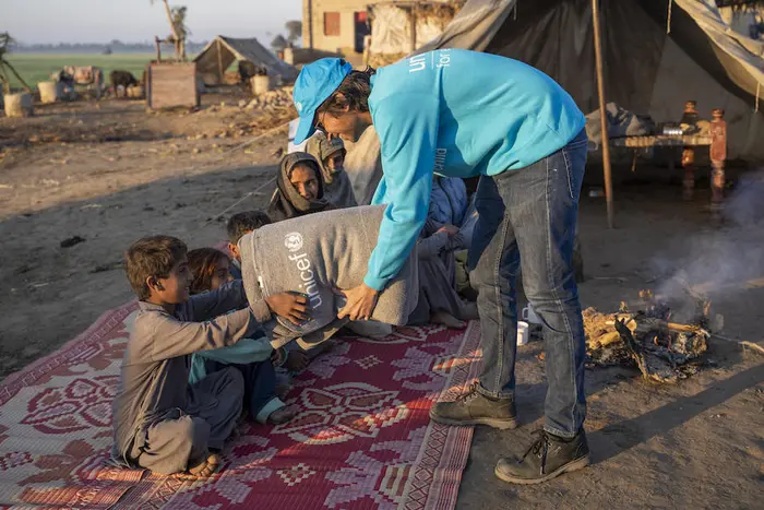 UNICEF Communication Officer Moeed Hussain gives a blanket to 6-year-old Shahbaz during UNICEF’s winter kits distribution in Zangi Brohi Village, Dadu District, Sindh Province. UNICEF Communication Officer Moeed Hussain gives a blanket to 6-year-old Shahbaz during UNICEF’s winter kits distribution in Zangi Brohi Village, Dadu District, Sindh Province.