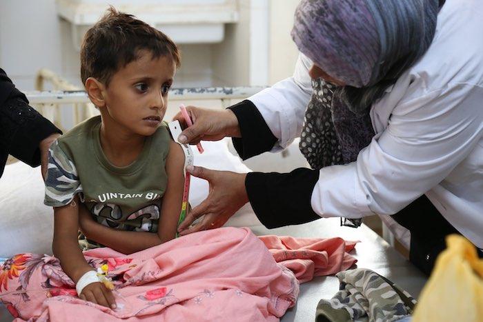 Cholera is life-threatening for young children, especially for those who are malnourished. Here, a child who contracted the deadly disease during Yemen’s massive 2017 outbreak has his arm measured by a health worker at the Alsadaqah Hospital in Aden to ch