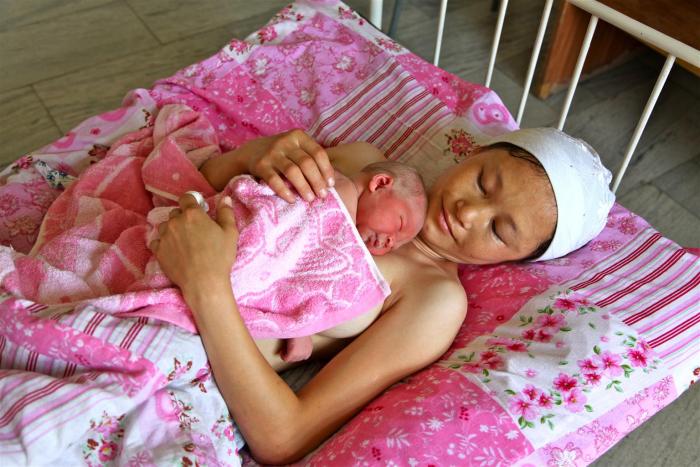 Jonsulu Shukurbaeva smiles at her newborn in the city of Khujayli’s hospital in Uzbekistan.