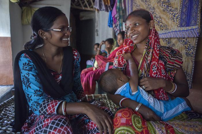 A community health volunteer advises a mother on breastfeeding, nutrition and infant care as part of a UNICEF-supported program in Jharkhand State, India.
