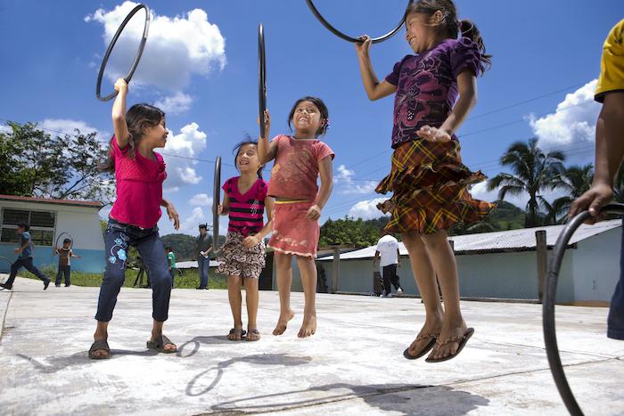 Children play with hula hoops in Chiapas, Mexico