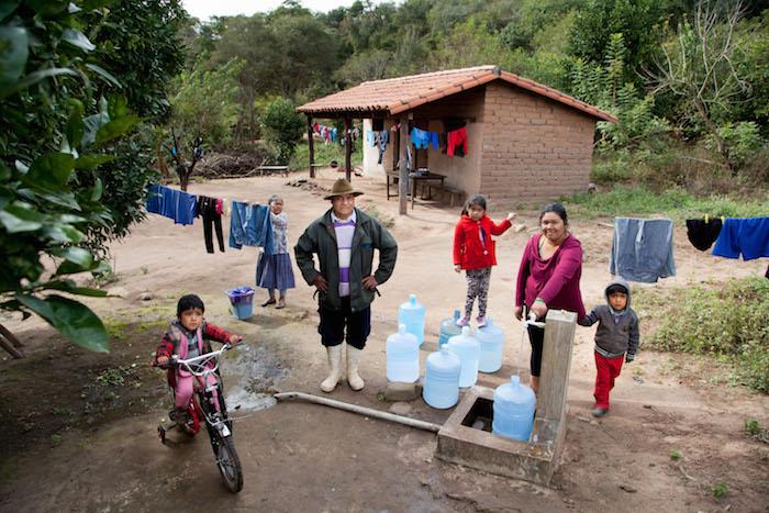 Thanks to UNICEF support this family in Bolivia is able to get water from a community tap near their home.
