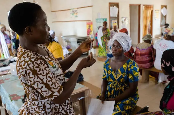 Emelia Kakarba preparing to administer a tetanus vaccine to Sadia Issah at an antenatal clinic at a Reproductive and Child Health facility in Savelugu in the Northern Region of Ghana