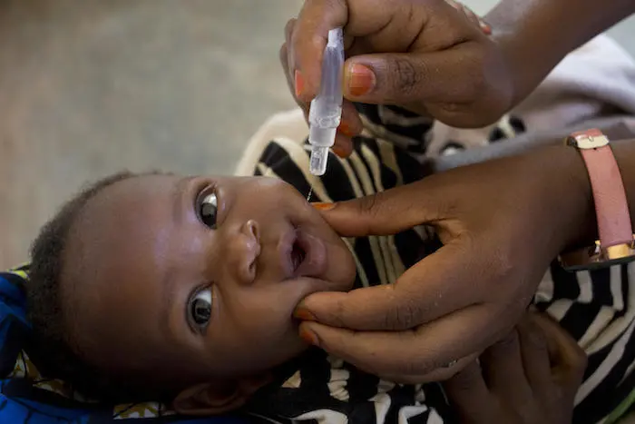 A child is vaccinated against polio at a UNICEF-supported health center in Burundi.