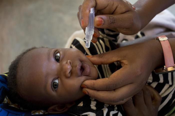 A child is vaccinated against polio at a UNICEF-supported health center in Burundi.