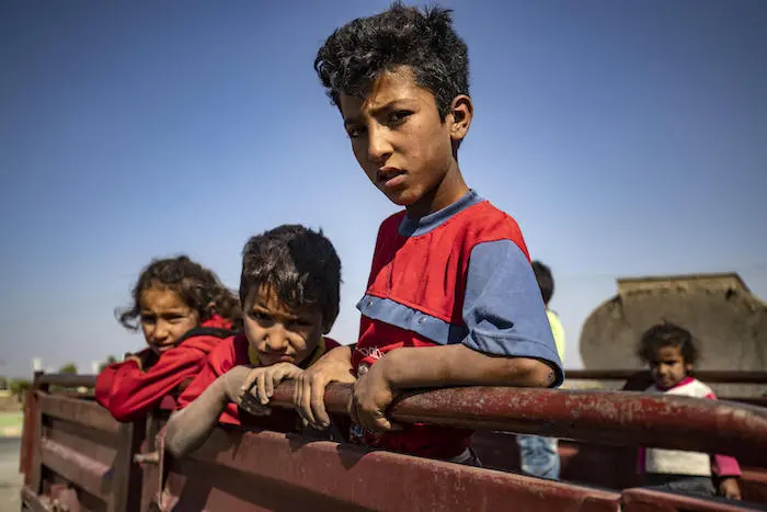 Fleeing Turkish bombardment, Syrian Arab and Kurdish civilians arrive in Tall Tamr town in the Syrian northwestern Hasakeh province on October 10, 2019.