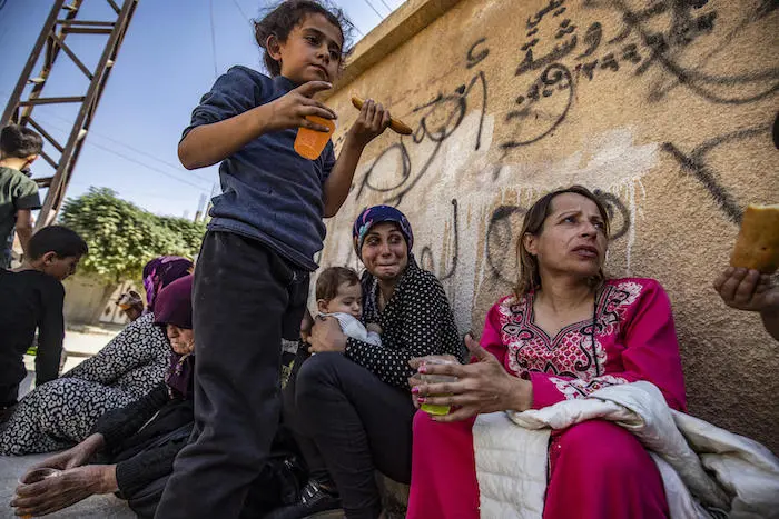 Syrian Arab and Kurdish civilians arrive to Hassakeh city after fleeing following Turkish bombardment on Syria's northeastern towns along the Turkish border on October 10, 2019. 
