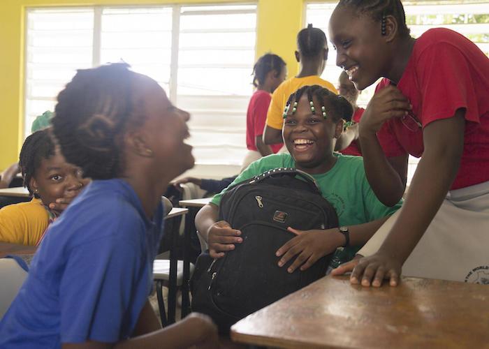 Eleven-year-old Jerrene (center) shares a laugh with fellow students at Princess Margaret Secondary School in St. John's, Antigua in 2019.