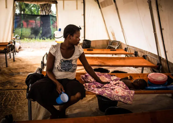 Mado Tshiabo sits beside her 3-year-old son, Costa, who is being treated for cholera at a UNICEF-supported treatment unit in Mbuji-Mayi, Democratic Republic of the Congo. 