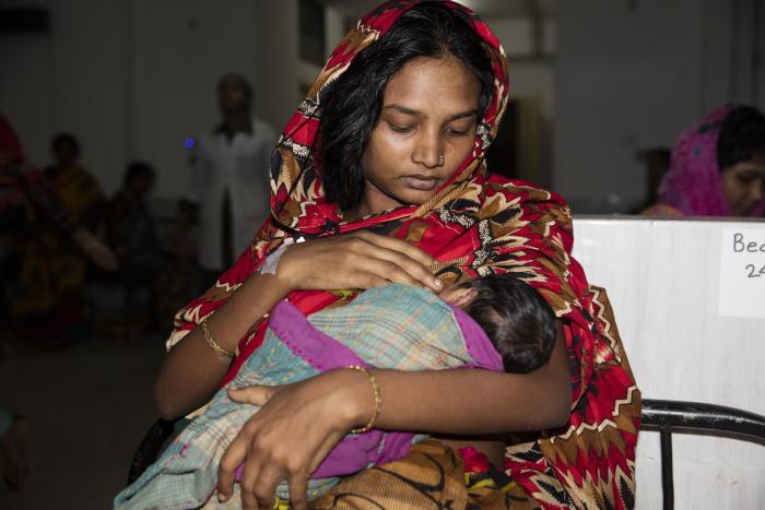 Ayesha Siddqa (18) practices breast feed her child in the women ward at Cox's Bazar Medical Hospital on 19 October 2017 in Cox's Bazar.