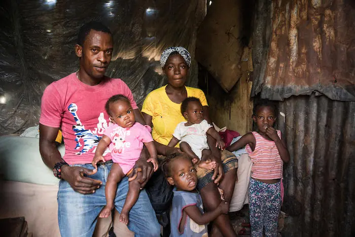 These parents, seen here in September 2019, registered their children's births in Anse d'Hainault, Haiti. 