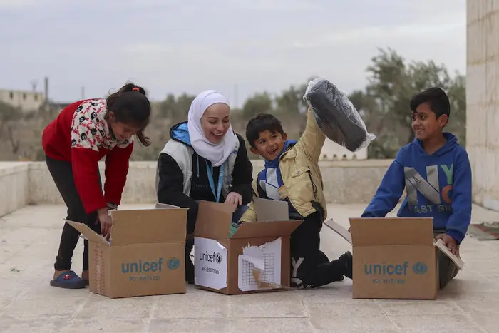 A family in Syria unpacks a box of warm winter clothing provided by UNICEF as part of as previous winter relief program. A family in Syria unpacks a box of warm winter clothing provided by UNICEF as part of a previous winter relief program.