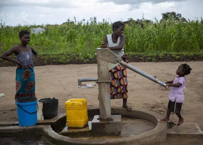 On March 4, 2020, residents of Ndjenja resettlement camp, Mozambique, use a well installed by UNICEF.