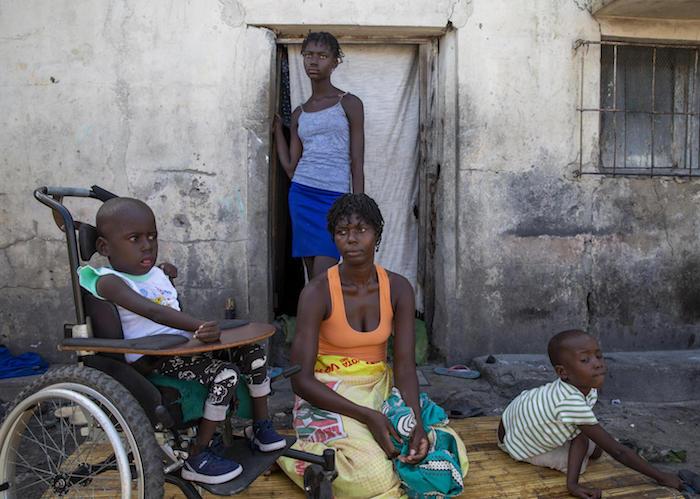Aissa Vali (center) with her daughter Anna and her twins, Elias (left) in his wheelchair that was provided by UNICEF, and Lazarus, at their home in Beira, Mozambique, on March 6, 2020.