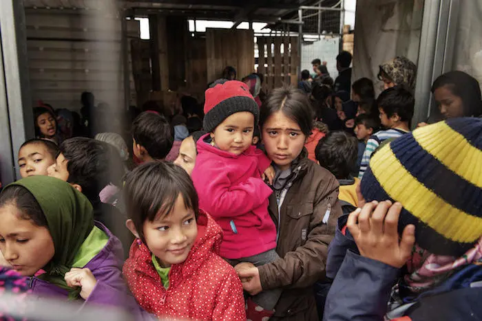 Children line up for fruit juice at a UNICEF-support center for refugees in Moria, on the Greek island of Lesvos. 