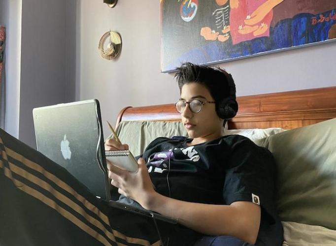 Jack, 14, attends online school while his parents telework at home in New York City during the coronavirus pandemic.