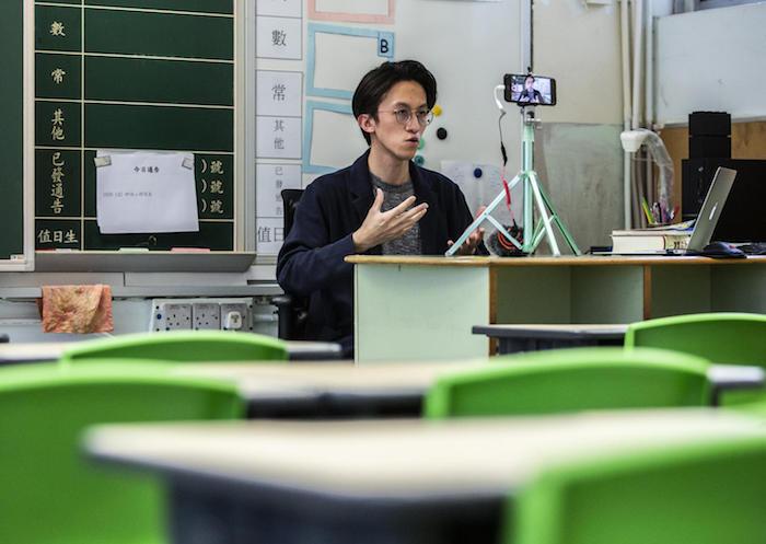 On March 6, 2020, primary school teacher Billy Yeung records a video lesson for his students who have had their classes suspended due to the COVID-19 coronavirus, in his empty classroom in Hong Kong. 