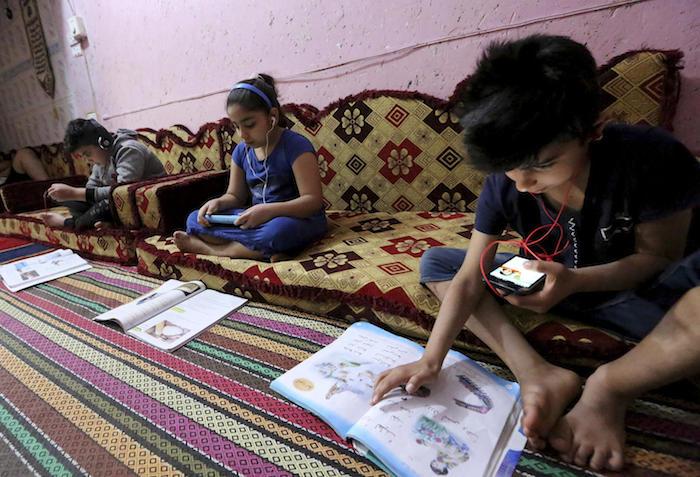 Iraqi children take their lessons remotely in Baghdad amidst a lockdown to fight the spread of the coronavirus COVID-19.