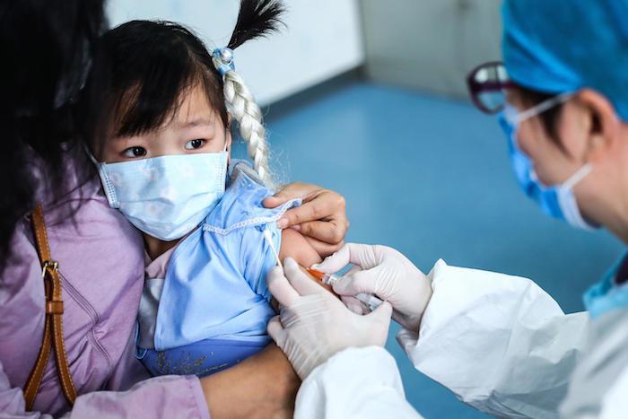 A 3-year-old girl receives a vaccine at a community health center in Beijing, China, on March 26, 2020. 