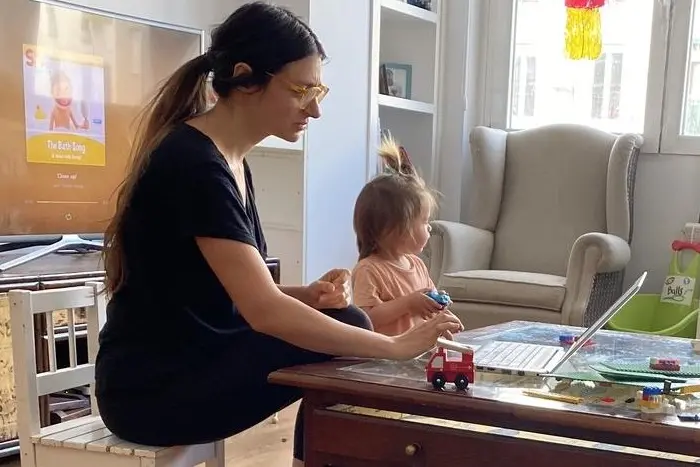 Ruben, 4, and his little sister play while their mother, Daniela, gets in a little work. Working from home makes it challenging for a parent to support their children’s home learning experience. Routines are different, rules are different, and parents and