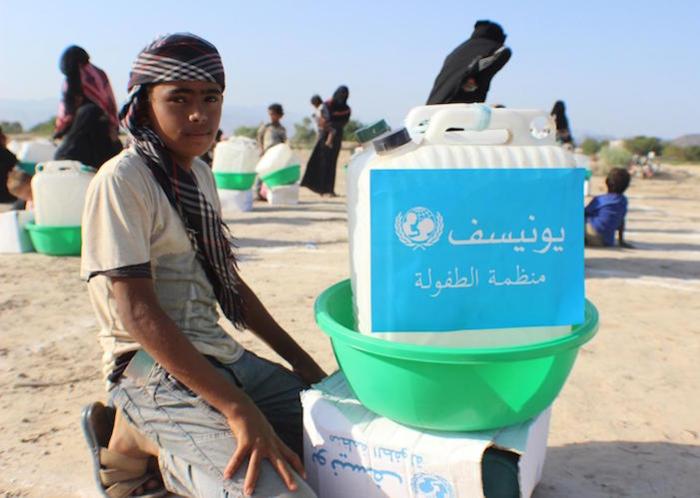 On April 27, 2020 in Abyan, Yemen, families displaced by insecurity collect UNICEF hygiene kits to protect them from the novel coronavirus. 
