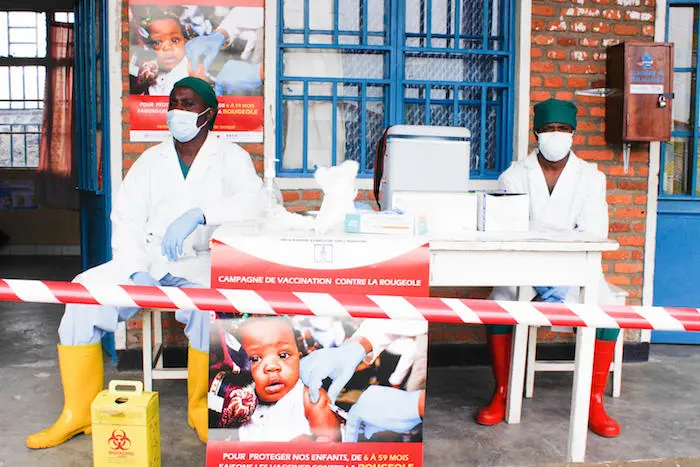 UNICEF-supported health workers masked and ready to administer measles vaccines in the Democratic Republic of Congo.