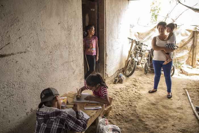 A mother and children at home in Guatemala where UNICEF is working with the government to support remote learning during the COVID-19 pandemic.