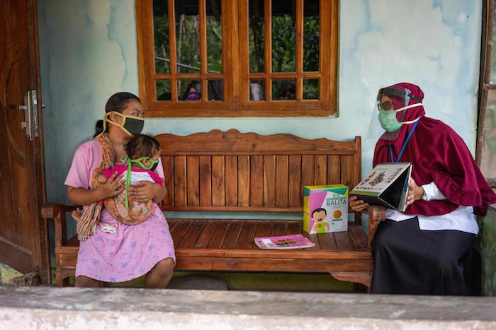 A nutritionist counsels the mother of a 2-year-old girl during a home visit in Paseban Village in Klaten, Central Java, Indonesia.