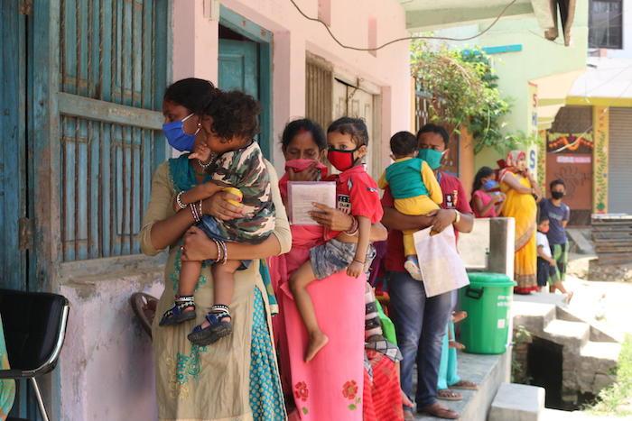 Parents and caregivers line up with their children outside a UNICEF-supported immunization clinic in Janakpur, southern Nepal.